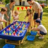 Enfants et adultes jouant à la pêche aux canards lors d’une animation familiale en extérieur.